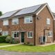 Suburban British house with solar panels and an air source heat pump installed, representing EPC energy efficiency grants for Oxfordshire landlords