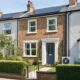 Modern English brick terrace with solar panels and an air source heat pump, showing energy efficiency upgrades that drive a rental premium